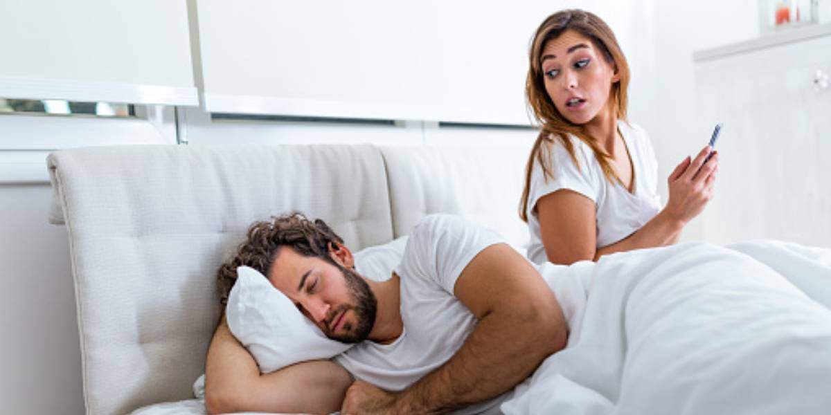 What Are the Signs of a Woman Cheating on You Wife quietly checking if husband is asleep at night
